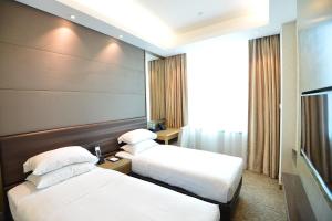 Voodi või voodid majutusasutuse Kew Green Hotel Mongkok toas