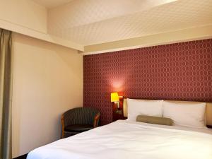Postel nebo postele na pokoji v ubytování Nakajimaya Grand Hotel