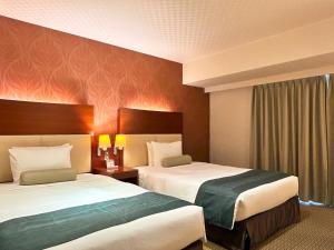 Postel nebo postele na pokoji v ubytování Nakajimaya Grand Hotel