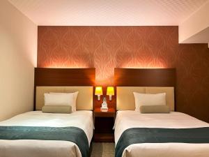 Postel nebo postele na pokoji v ubytování Nakajimaya Grand Hotel