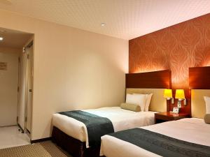 Postel nebo postele na pokoji v ubytování Nakajimaya Grand Hotel