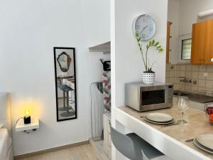 a kitchen with a counter with a microwave on it at Marvel City Studio in the centre in Rethymno
