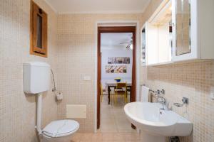 a bathroom with a white toilet and a sink at Villa Gaudì - Batllò in Sant'Isidoro +23 photos