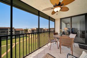 a patio with a table and chairs on a balcony at Loggerhead Cay #434 in Sanibel