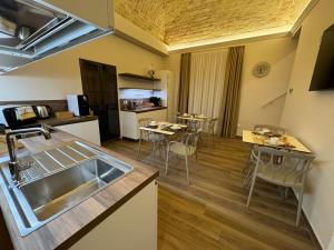 a kitchen and living room with a sink and a table at B&B Palazzo Croghan in Torre Maggiore