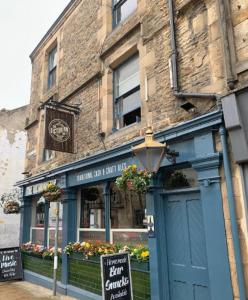 a building on a street with a sign in front of it at The Victorian Tap in Hexham
