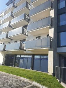 a building with balconies on the side of it at Apartament Browarna in Nowy Sącz