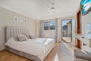 a bedroom with a king sized bed and a television at Monda Palms Ground Floor Apartment in Monda in Monda +17 photos