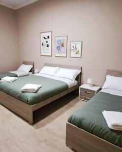 two beds in a room with two beds sidx sidx sidx sidx at Casa Vacanze Enrica House in Naples