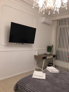 a living room with a flat screen tv on the wall at Sun apartments in Kyiv