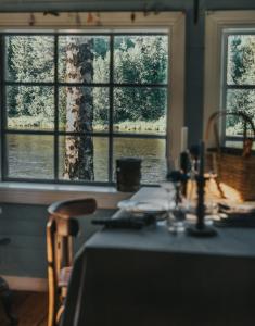 a table in a room with a view of a window at Cabin by Byske river surrounded by the forest in Byske