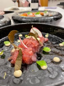 a plate of food with meat and vegetables on it at Palazzo Durante in Letojanni