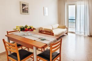 a living room with a table and a couch at Tourist Residence in San Benedetto del Tronto