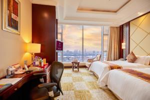 a hotel room with two beds and a large window at Soluxe Hotel Guangzhou - Registration Service and Free Shuttle Bus to Canton Fair Complex in Guangzhou