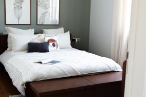 a bedroom with a white bed with a mask on it at Casa Idalia Boutique Hotel in Comporta