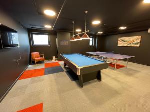 a ping pong room with two ping pong tables at Brand New 2BR2Bath Family Home Manuka Inner South in Kingston 