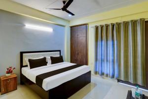 a bedroom with a bed and a ceiling fan at OYO YUVRAJ RESIDENCY in Noida