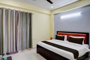 a bedroom with a large bed and a window at OYO YUVRAJ RESIDENCY in Noida