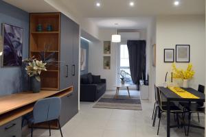 a kitchen and living room with a table and chairs at T&N Central Amazing Apartment in Thessaloniki