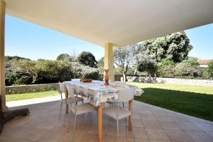 a table and chairs sitting on a patio at Residence Rena Majore in Rena Majore