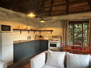 a kitchen with a couch and a stove top oven at Wyford Farm in Van Reenen