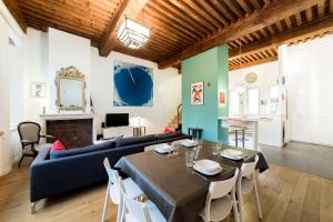 a living room with a blue couch and a table at Large duplex in the heart of Old Lyon in Lyon