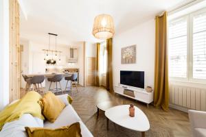 a living room with a couch and a tv at Exceptional and quiet near Part-Dieu AIL in Lyon