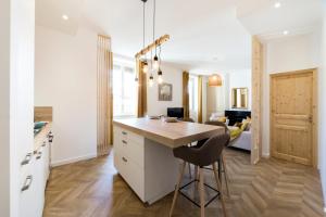 a kitchen with a island with a chair and a table at Exceptional and quiet near Part-Dieu AIL in Lyon