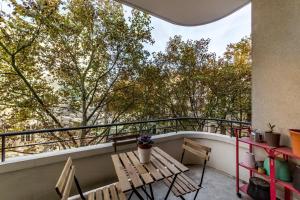 - un balcon avec une table, des chaises et des arbres dans l'établissement Spacious and bright 70m² square AIL, à Lyon
