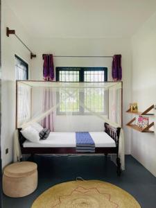 a small room with a bed and a window at Adventurevilla in Kendwa