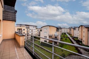 a balcony with a view of a city at Borkowska Comfort Apartment in Krakow