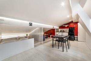 a kitchen and living room with a table and chairs at Central Studio Jacobins AIL in Lyon