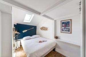 a bedroom with a bed with a teddy bear on it at The artistic loft of Croix-Rousse AIL in Lyon