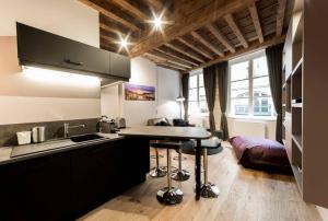 a kitchen with a sink and a table in a room at Jewel apartment in Vieux Lyon AIL in Lyon