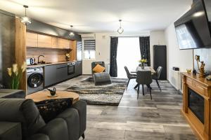 a living room with a couch and a table at WES Apartment Grand Park in Cluj-Napoca