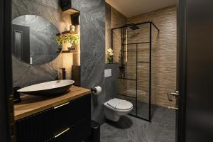 a bathroom with a sink and a toilet at WES Apartment Grand Park in Cluj-Napoca +61 photos