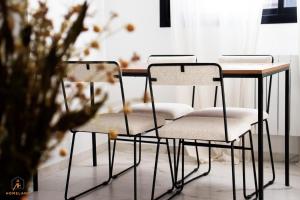 two chairs sitting at a table in a room at pool house in Douar ech Chott