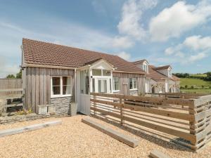 a house with a wooden fence in front of it at Garland in Weymouth