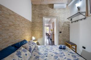 a bedroom with a bed and a brick wall at Villa Gaudì - Vicens in Sant'Isidoro