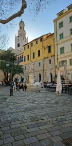 a building with a fountain in the middle of a courtyard at Casa di MAGGIE in Sanremo