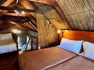 a bedroom with two beds in a attic at Wyford Farm in Van Reenen