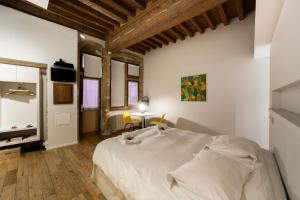 a bedroom with a large bed and a table at Le Petit Change - Fully equipped studio in Lyon in Lyon