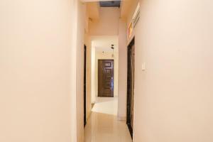 a hallway of a house with white walls at FabExpress Girija Inn in Nagpur