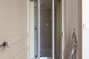 a shower with a glass door in a bathroom at Enjoy Residencé Château de Monbrison, apartment for two guests in Saint-Michel +28 photos