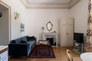a living room with a couch and a fireplace at Enjoy Residencé Château de Monbrison, apartment for two guests in Saint-Michel