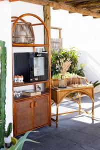 a television on a stand next to a table at Casa Idalia Boutique Hotel in Comporta