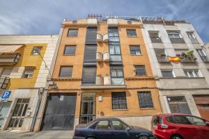 two cars parked in front of a building at Apto Omeya & Center & Parking in Córdoba