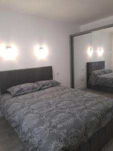 a bedroom with a bed and two lights on the wall at Impeccable 2-Bed Apartment in London in Hendon