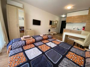 a bedroom with a large bed with pillows on it at Apartments Amara Sunny Beach in Sunny Beach