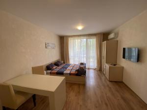a small room with a bed and a window at Apartments Amara Sunny Beach in Sunny Beach